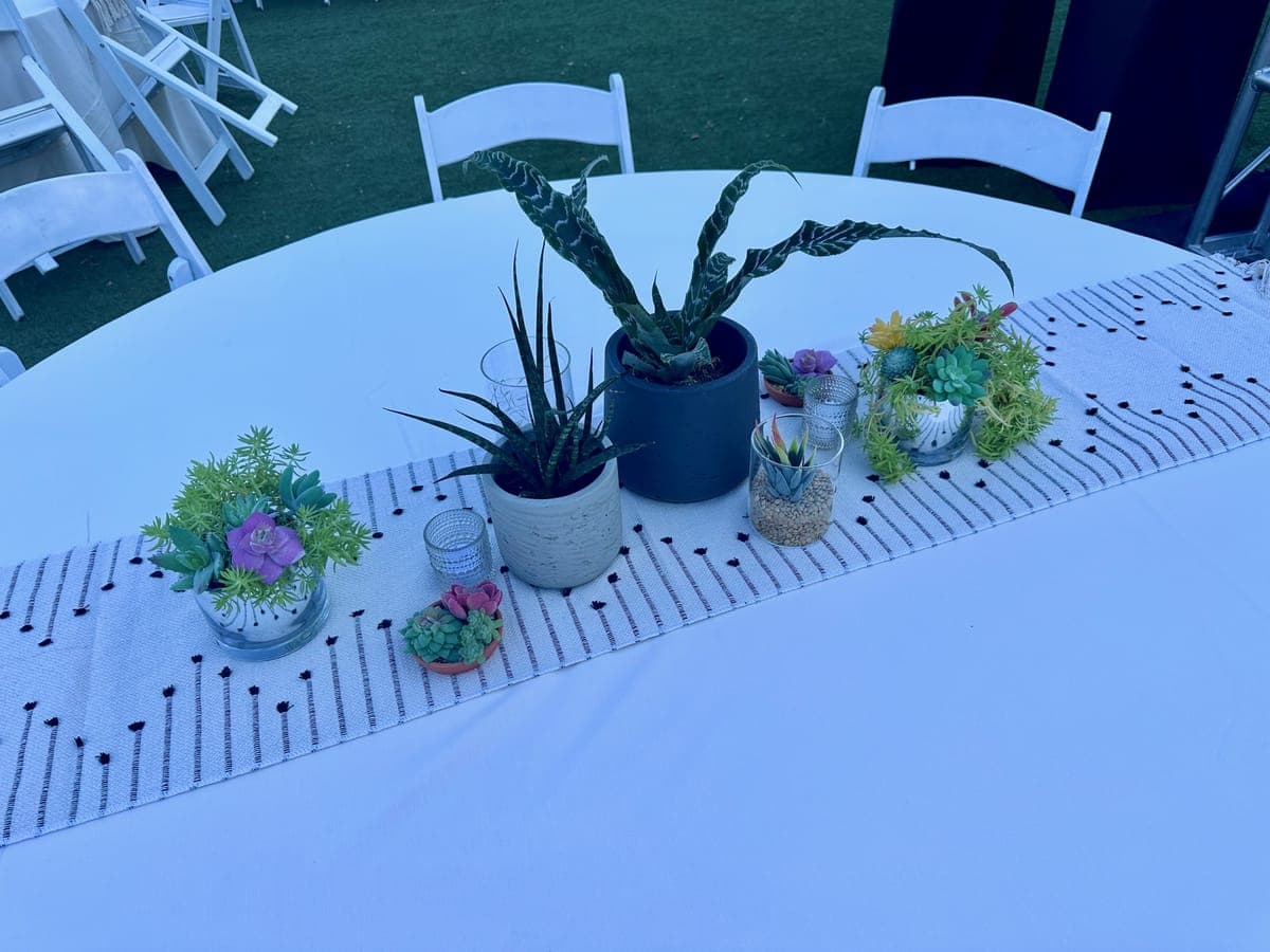 Sweetheart table with cascading floral arrangement at a garden wedding