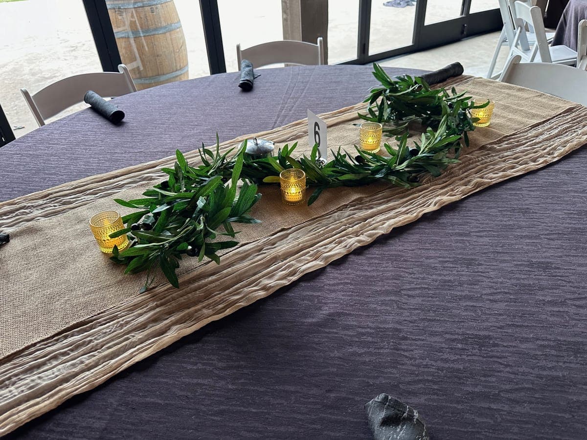 Church event fellowship hall decorated with seasonal florals and candles